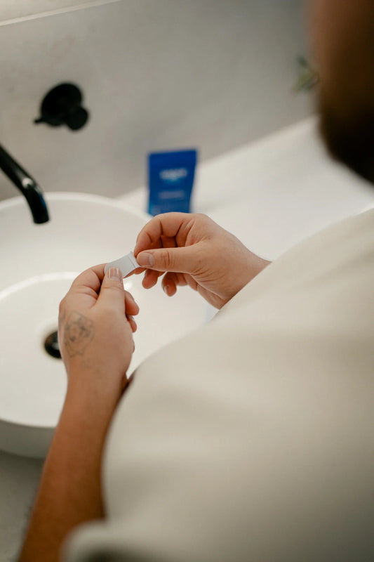 Snoring Nasal Strip Held By A Woman Preparing To Put It On Her Nasal Bridge