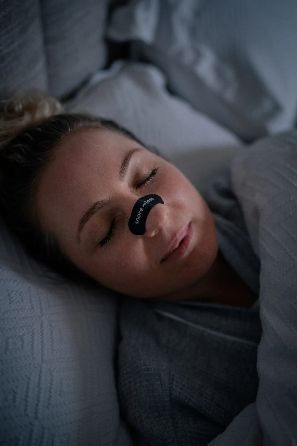 Sleeping Woman Wearing The Snore Less Black Snoring Strips
